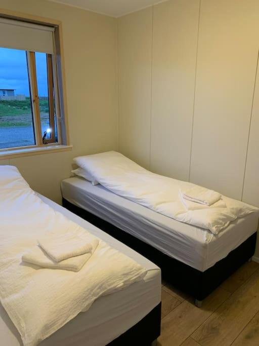 Twin beds in a bedroom at Hafnir Guesthouse